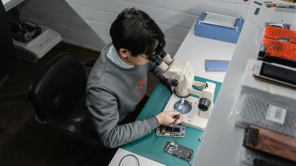 Technician inspecting a phone at the workbench