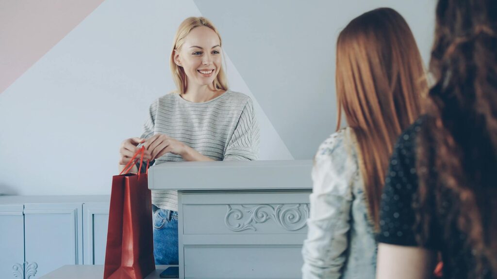 Customer picking up a repaired phone at the counter